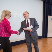 3MT Third Place winner Sarah Thompson shaking hands with the dean of the graduate school